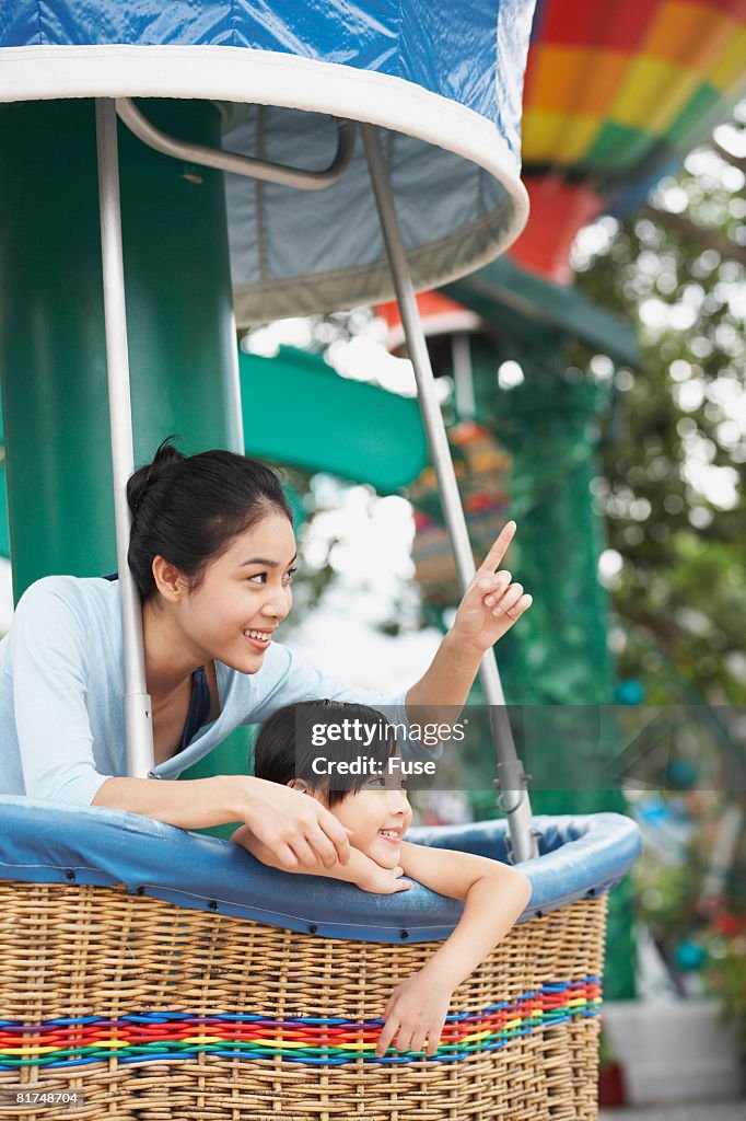 Mother and Daughter Riding Amusement Ride