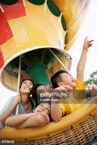 family riding amusement ride - hot air balloon ride stock-fotos und bilder