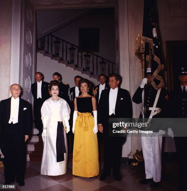 President John F. Kennedy and Jacqueline Kennedy, right, pose for a photograph with guests before a dinner in honor of the President of Peru, left,...