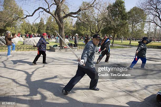 Tai chi with swords in park of the Temple of Heaven, Beijing, China