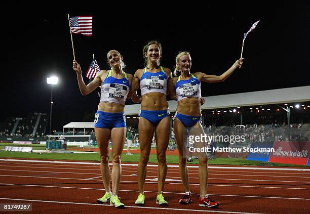 The U.S. Olympic team of Amy Begley, Kara Goucher and Shalene Flanagan pose with flags after finsihing the top three in the women's 10,000 meter...