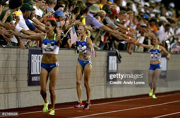 The U.S. Olympic team of Kara Goucher, Shalene Flanagan and Amy Begley celebrate with fans after finishing in the top three in the women's 10,000...