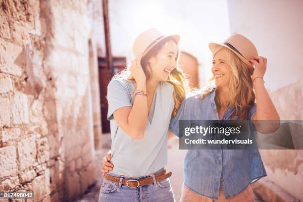 mother and daughter on summer holidays walking in old village - dia da mãe imagens e fotografias de stock