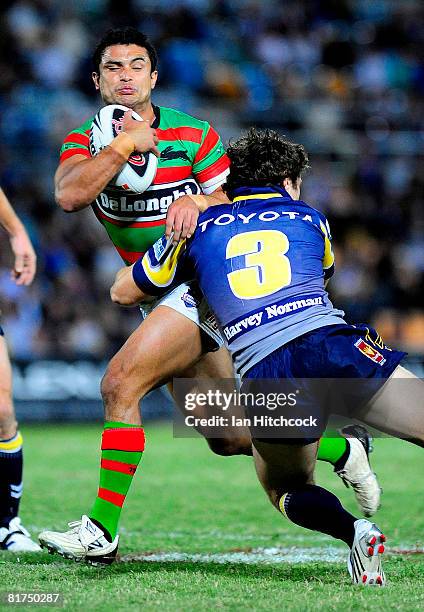 Craig Wing of the Rabbitohs is tackled by Ashley Graham of the Cowboys during the round 16 NRL match between the North Queensland Cowboys and the...