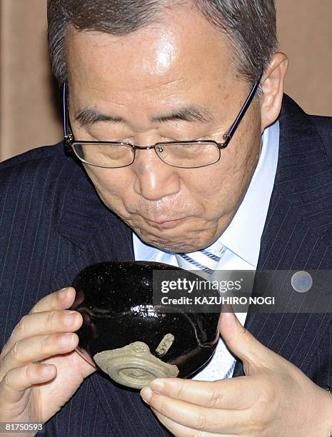 Secretary General Ban Ki-Moon drinks a cup of Japanese traditional tea during a welcoming tea ceremony at the Urasenke home Konnichian in Kyoto on...