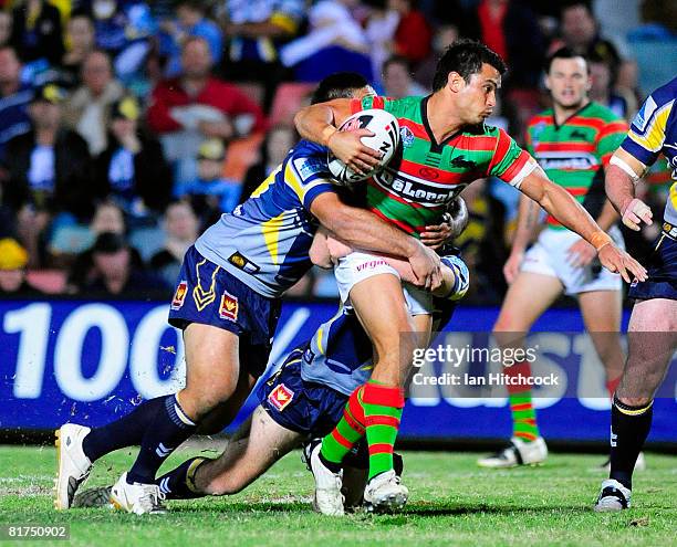 Craig Wing of the Rabbitohs looks to get through the Cowboy defence during the round 16 NRL match between the North Queensland Cowboys and the South...