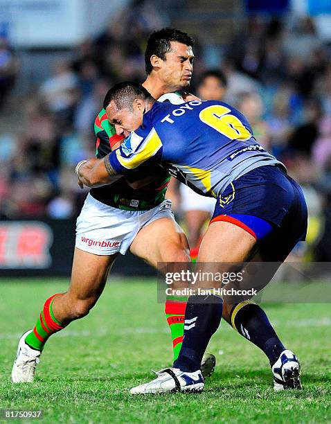 Craig Wing of the Rabbitohs is tackled by Sione Faumuina of the Cowboys during the round 16 NRL match between the North Queensland Cowboys and the...