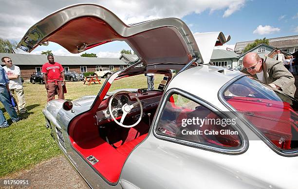 Man places the racing number on a 1955 Mercedes-Benz 300SL Gullwing at the Brooklands Motoring Festival 2008, 'The Double Twelve' on June 28, 2008 in...