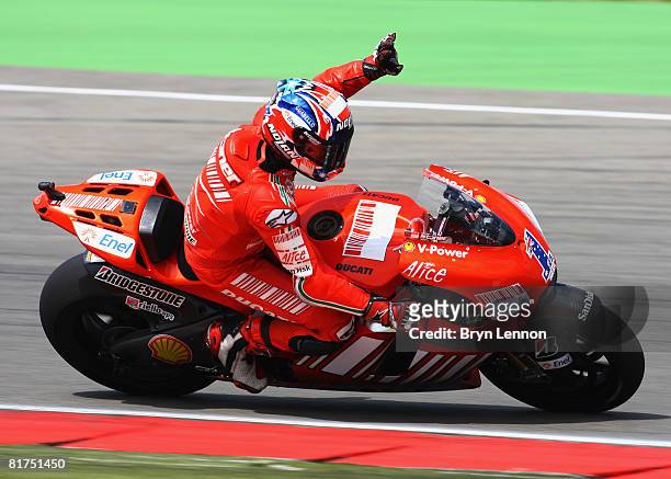 Casey Stoner of Australia and the Ducati Marlboro Team waves to the crowds after winning the Dutch MotoGP race at the Assen TT Circuit on June 28,...