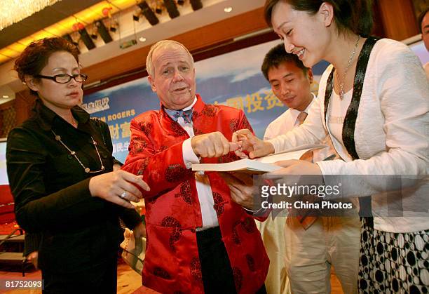 International investor Jim Rogers signs autograph for a Chinese woman at a fortune forum held by a Chinese bank and a local newspaper on June 28,...