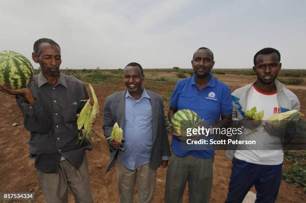 Somali village elders hold watermelons and corn harvested from a Farmer Field School organized by the Irish aid agency Concern-Worldwise as the Horn...