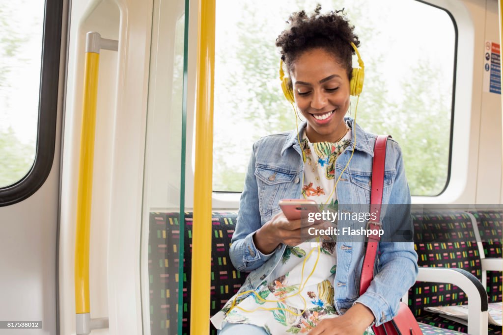 Woman using her phone on a train