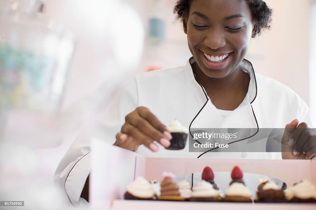 Baker Arranging Cupcakes