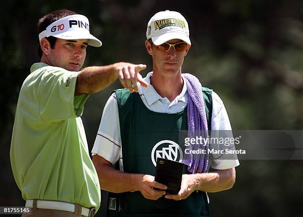 Bubba Watson chats with his caddie on the 8th hole during the third round of the Buick Open at Warwick Hills Country Club on June 28, 2008 in Grand...