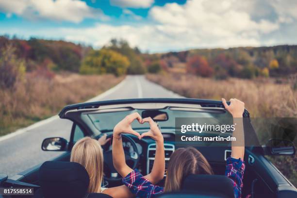 young women on a road trip with cabriolet - fall road trip stock pictures, royalty-free photos & images