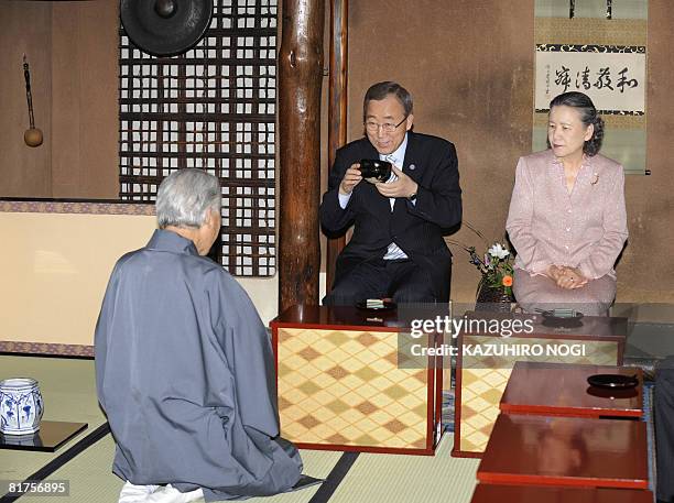 Secretary General Ban Ki-Moon , accompanied by his wife Yoo Soon-Taek , drinks a cup of Japanese traditional tea made by Sen Genshitsu , former grand...