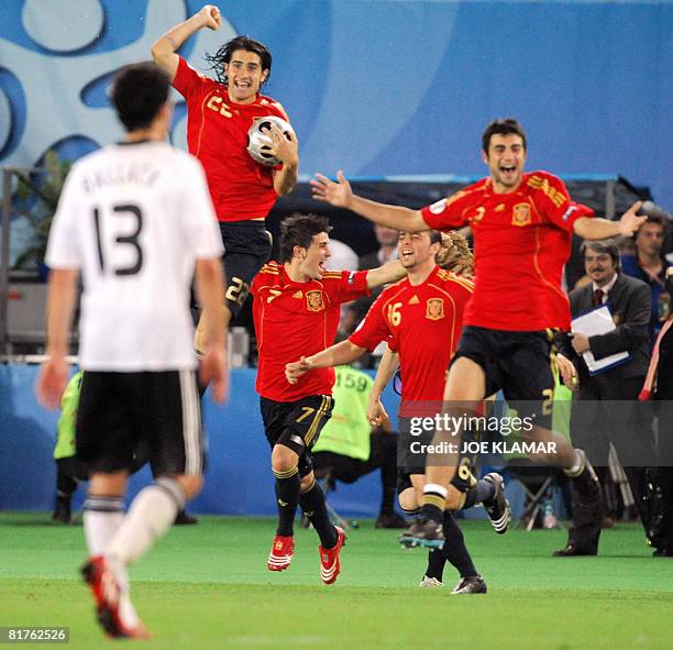 Spanish midfielder Ruben de La Red, forwards David Villa and Sergio Garcia and defender Raul Albiol celebrates past German midfielder Michael Ballack...