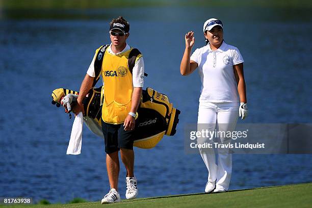 InBee Park of Korea and her caddie Brad Beecher walk up the 18th fairway during the final round of the 2008 U.S. Women's Open at Interlachen Country...