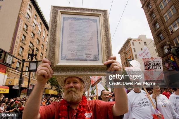 Jimmy Criss carries his wedding license as he takes part in the 38th Annual San Francisco Lesbian, Gay, Bisexual, Transgender Pride Celebration &...