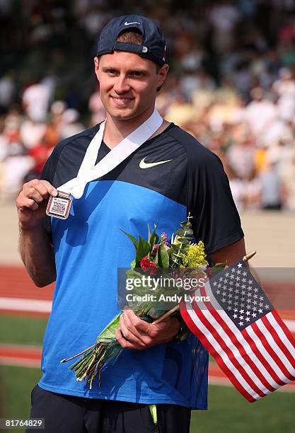 Brad Walker poses with his bronze medal in the men's pole vault final during day three of the U.S. Track and Field Olympic Trials at Hayward Field on...