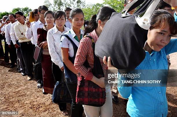 People are seen lining outside the first public hearing against the detention of former Khmer Rouge deputy prime minister and minister of foreign...