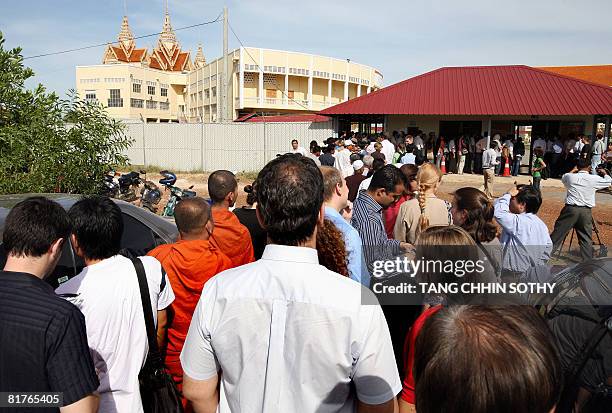 People are seen outside the first public hearing against the detention of former Khmer Rouge deputy prime minister and minister of foreign affairs...