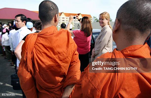 People are seen lining up outside the first public hearing against the detention of former Khmer Rouge deputy prime minister and minister of foreign...