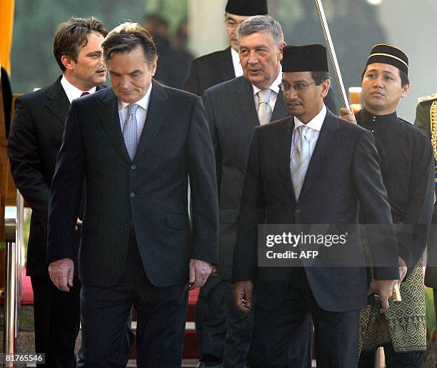 Malaysian King Mizan Zainal Abidin walks with members of the Bosnian Presidency Zeljko Komsic Haris Silajdzic and Nebojsa Radmanovic after an...
