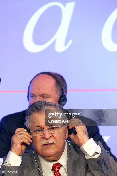 Iraqi President Jalal Talabani adjusts his earphone during the 23rd Congress of the Socialist International at the Lagonissi Grand Resort, some 40 km...