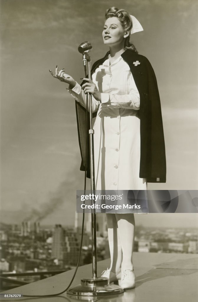 Female nurse speaking into microphone on rooftop