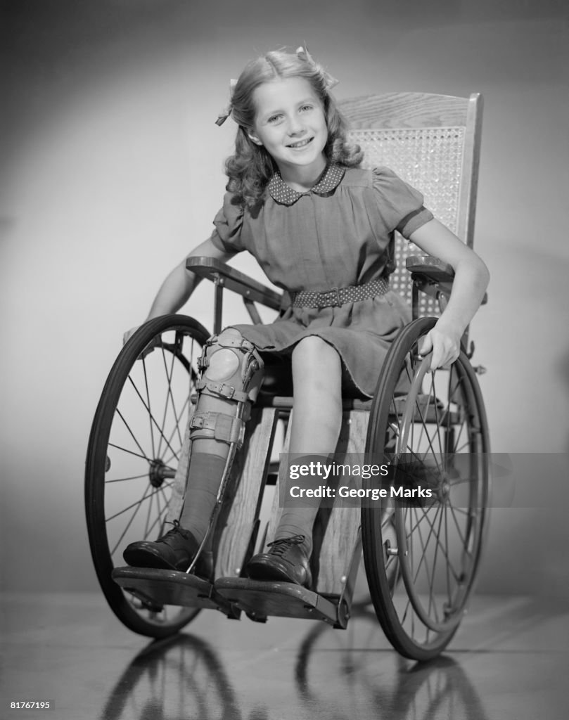 Studio portrait of girl (10-11) in wheelchair