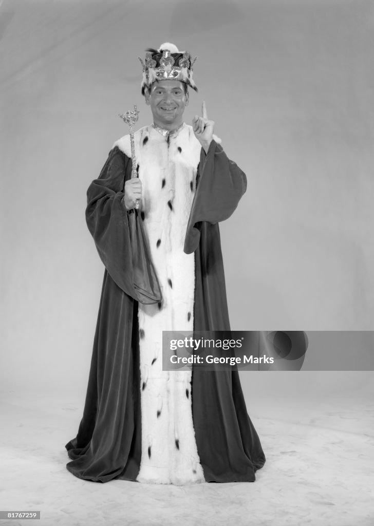 Man dressed as king portrayed against white backdrop