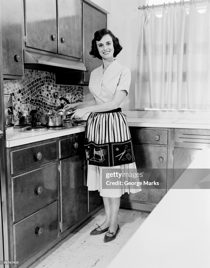 Woman cooking in domestic kitchen, portrait