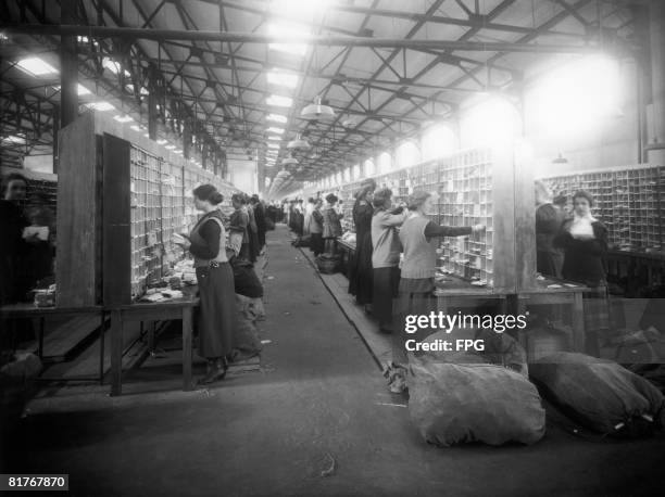 Women postal workers at a sorting office, circa 1920.