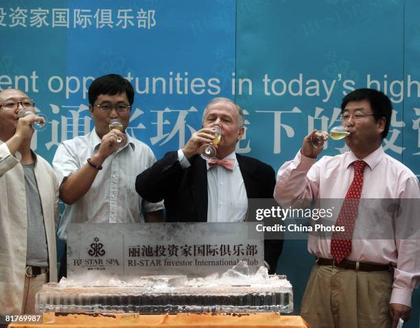 International investor Jim Rogers , chairman of Rogers Holdings, drinks with business people to celebrate the opening of an investor club, during a...