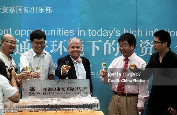 International investor Jim Rogers , chairman of Rogers Holdings, drinks with business people to celebrate the opening of an investor club, during a...