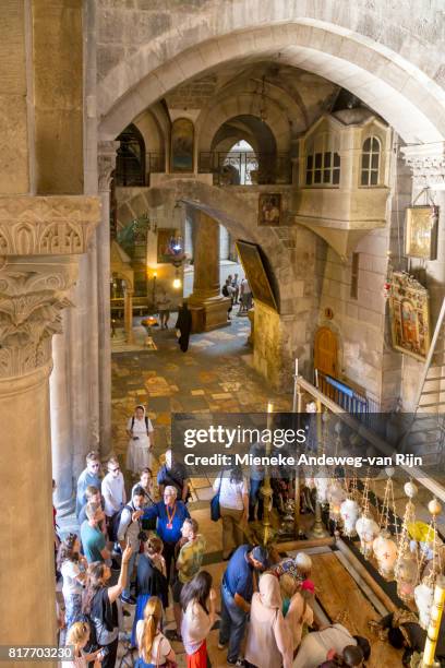 visitors at the stone of unction in the church of the holy sepulchre, jerusalem, israel. - mieneke andeweg stock pictures, royalty-free photos & images