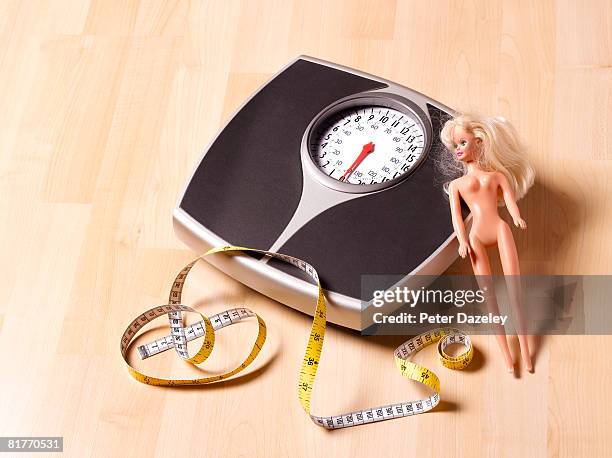 bathroom scales, tape measure and doll - body conscious stock pictures, royalty-free photos & images