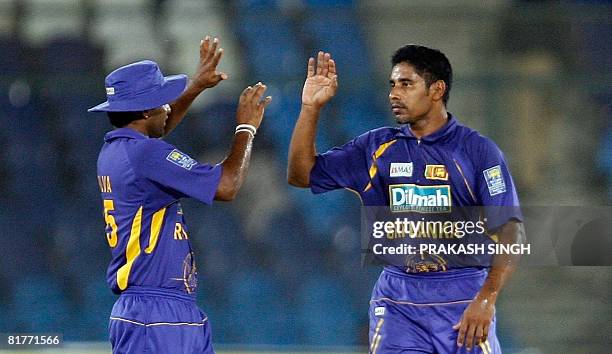 Sri Lanka cricketer Chaminda Vaas celebrates the wicket of Bangladesh cricketer Tamim Iqbal Khan with Chamar Silva during the Super League Asia Cup...