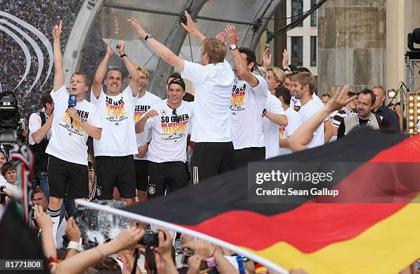 Oliver Pocher and members of the German national football team greet fans gathered at the Fan Mile in front of the Brandenburg Gate upon the team's...