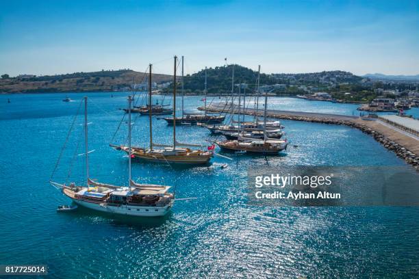 sailing boats anchored in turquoise waters of bodrum bay,near the st. peter castle,mugla province,turkey - mugla province stock pictures, royalty-free photos & images