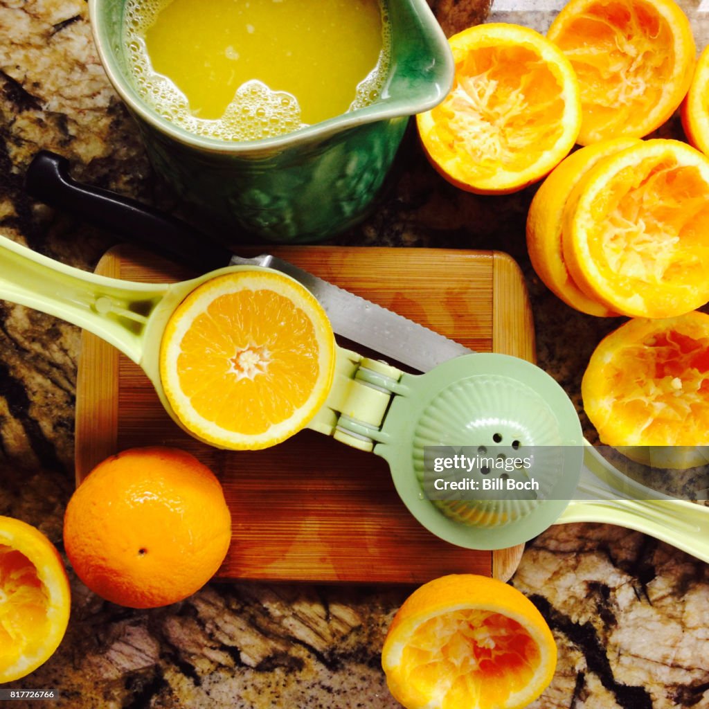 Oranges being squeezed for fresh orange juice