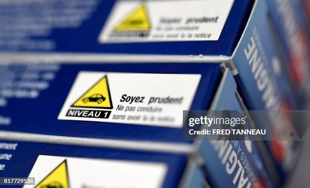 This photograph taken on July 18 shows a warning about driving on packets of painkilling pills which contain codeine in a pharmacy in Quimper,...