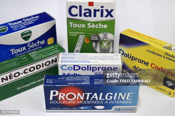 This photograph taken on July 18 shows packets of painkilling pills which contain codeine in a pharmacy in Quimper, western France. - In France...