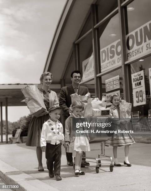 family carrying groceries home. - 1950s couple stock pictures, royalty-free photos & images