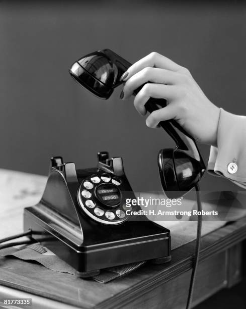 woman's hand picking up phone receiver. - telefonlur bildbanksfoton och bilder