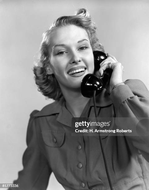 smiling woman on the telephone wearing a long sleeve shirtdress with cuffs & 2 button flaped chest pockets warm friendly exuberant. - 1940 18-21 stock pictures, royalty-free photos & images