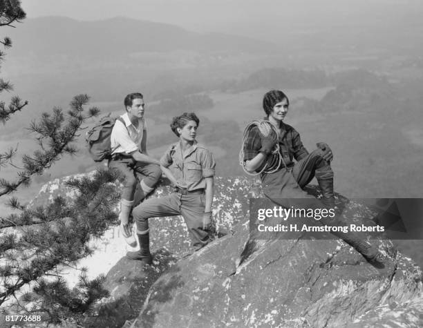 group of three climbers atop mountain. - people climbing walking mountain group stockfoto's en -beelden