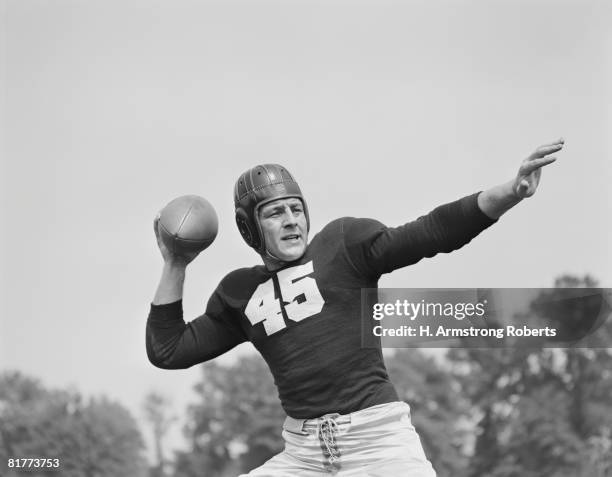 american football player poised to throw ball. - quarterback player stock pictures, royalty-free photos & images