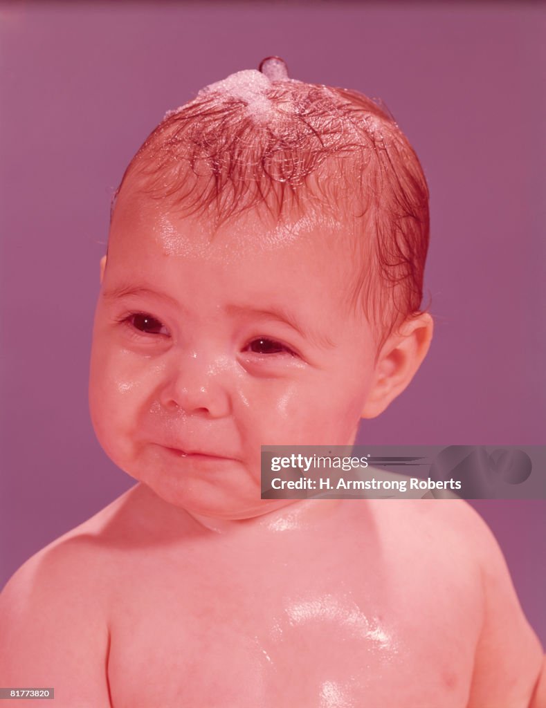 Wet baby with sad expression, portrait. (Photo by H. Armstrong Roberts/Retrofile/Getty Images)